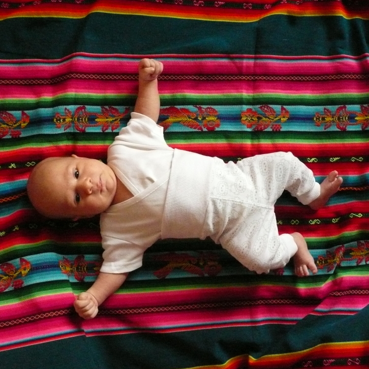 A baby lies on an aguayo, a traditional sling in Bolivia.