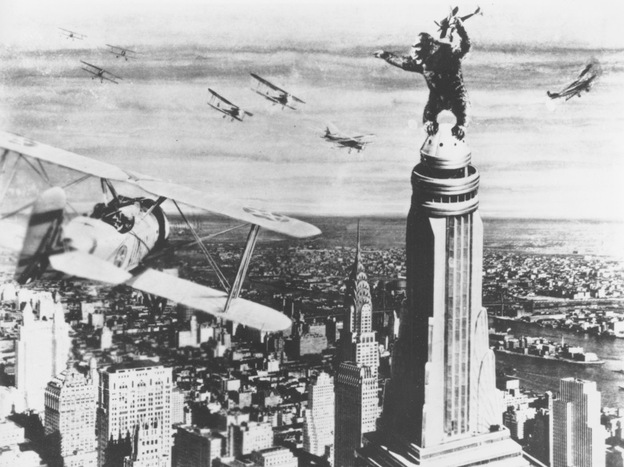 King Kong stands atop New York's Empire State Building as he holds an airplane during an attack by fighter planes in a scene from the 1933 film King Kong.