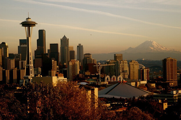 Mount Rainier looms in the background, and the Space Needle (far left) punctuates the city's skyline. Clausen has set three crime novels in Seattle, where he worked as a police officer for 13 years.