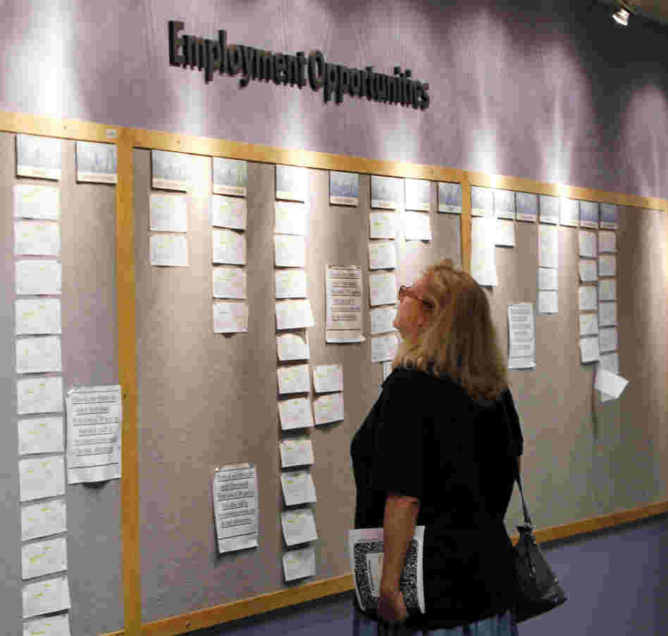 Lori Kamlet looks at posted employment opportunites at a Denver Employment office on Friday, July 22, 2011.