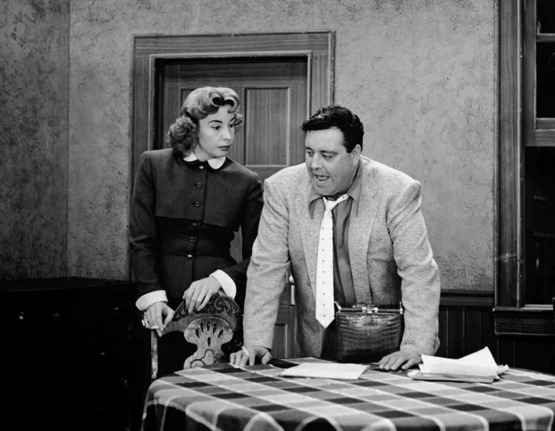 Jackie Gleason (right) played Ralph Kramden — a bumbling but loveable overweight husband — in the 1950s sitcom The Honeymooners. Audrey Meadows co-starred as his wife, Alice.