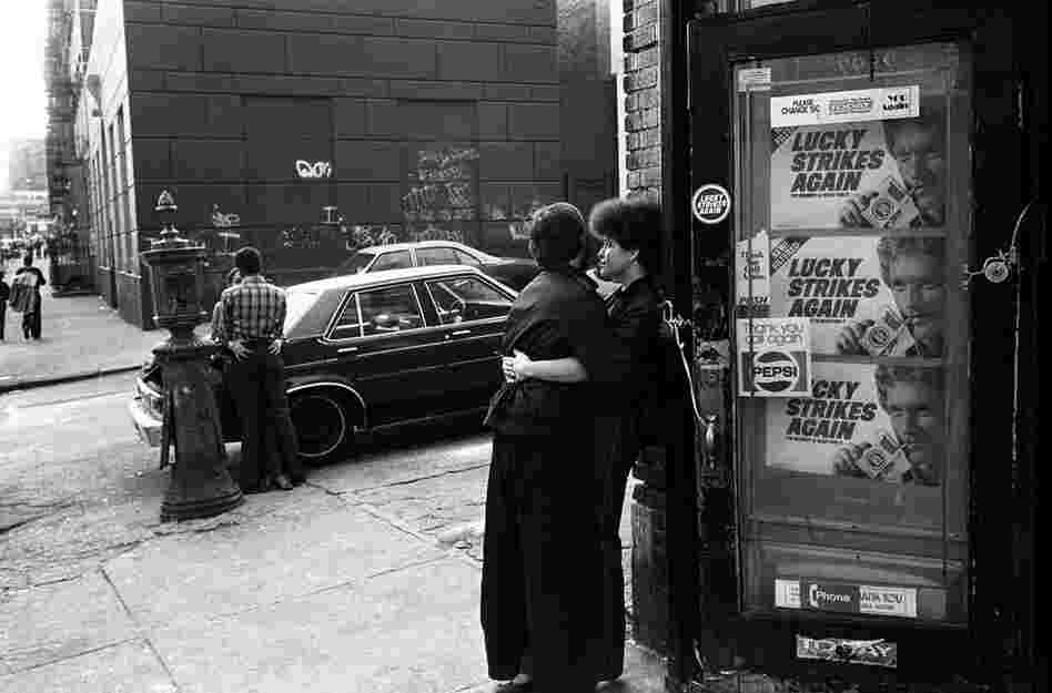Teenage couples kiss on the street corner, 1980s