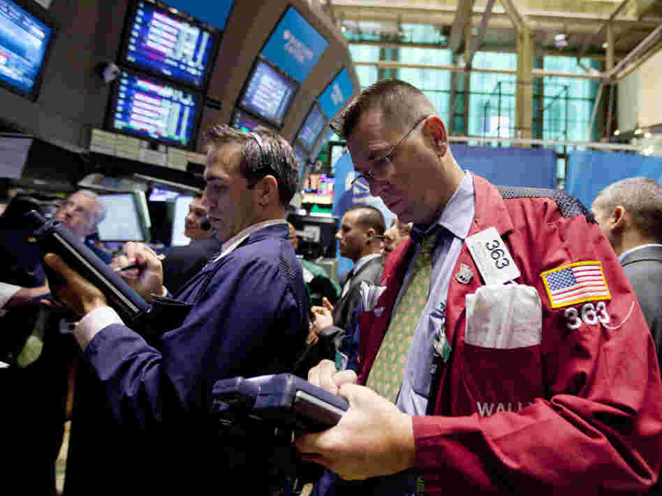 Traders work on the floor of the New York Stock Exchange on Thursday in New York. Stocks are plunging in another broad sell-off as investors grow concerned about an economic slowdown in the U.S. and Europe.