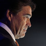 Texas Gov. Rick Perry looks on during a speech at a Boy Scout ceremony in June aboard the USS Midway in San Diego. At that dinner, he said the federal government is rudderless. Now, he's calling for a "day of prayer and fasting on behalf of our nation."