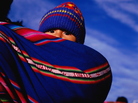 A young child wrapped in an aguayo, a traditional sling, on mother's back in La Paz, Bolivia. A young child wrapped in an aguayo, a traditional sling, on mother's back in La Paz, Bolivia.