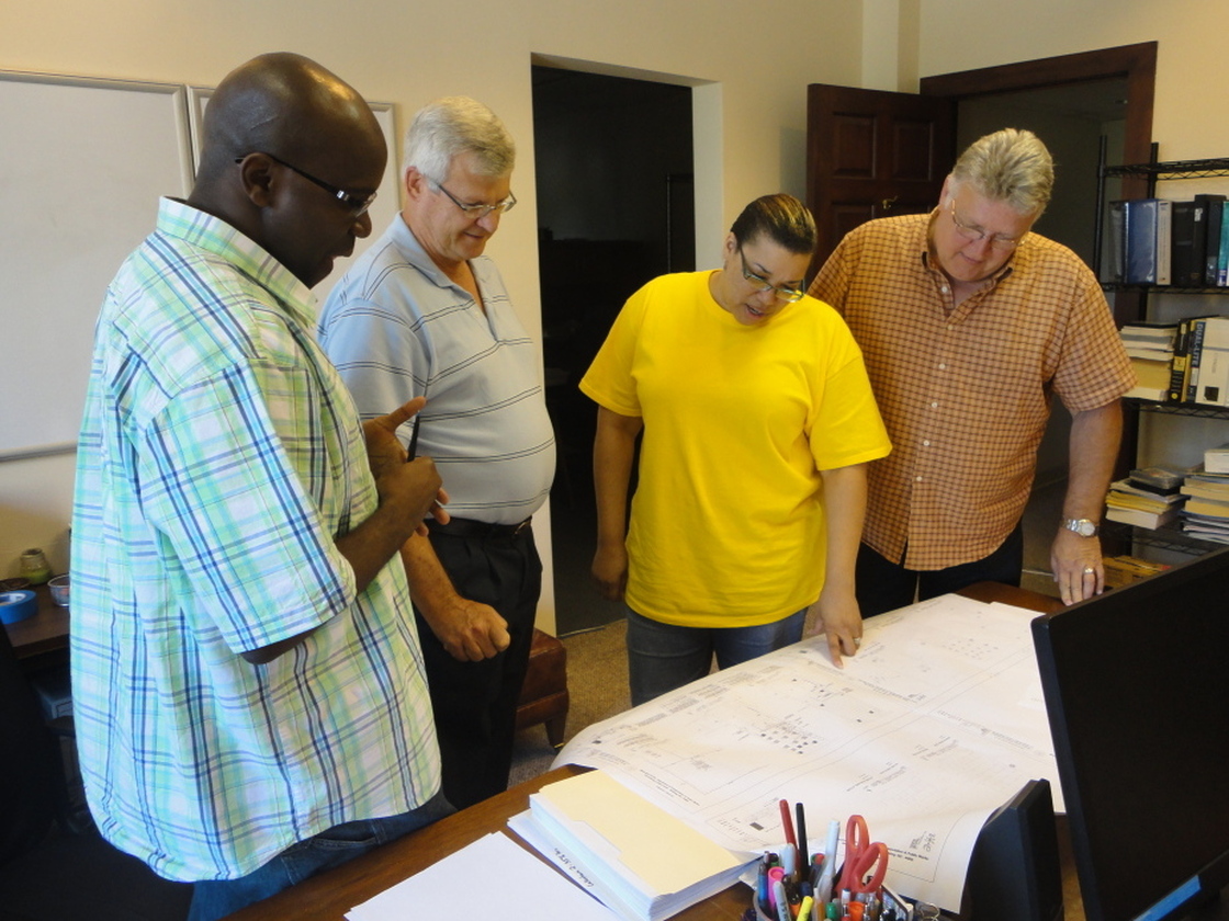 Daphne Wilson (center) and her engineering team review plans for control systems at General Mitchell International Airport in Milwaukee, Wis.
