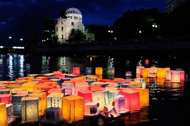 Paper lanterns to commemorate the victims of the bombing of Hiroshima float in the Motoyasu River in front of the Atomic Bomb Dome, in Hiroshima, Japan, on Saturday.
