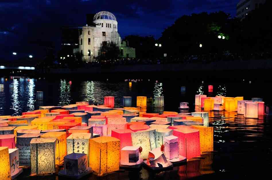 Paper lanterns to commemorate the victims of the bombing of Hiroshima float in the Motoyasu River in front of the Atomic Bomb Dome, in Hiroshima, Japan, on Saturday.