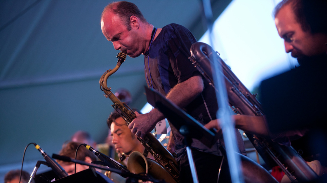 Dan Willis, on tenor saxophone, performs with the John Hollenbeck Large Ensemble on the Quad Stage during the Newport Jazz Festival.