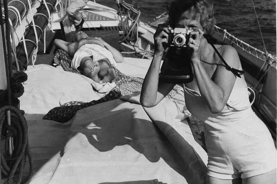Aline Saarinen taking a photograph, circa 1955 
