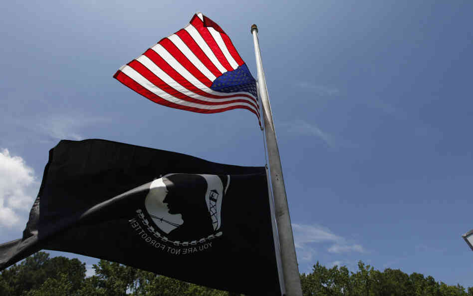 A U.S. flag and a POW/MIA flag fly at half-staff at a sports bar near the main gate of Naval Air Station Oceana/Dam Neck Annex, the base of Navy SEAL Team Six in Virginia Beach, Va., Monday. A U.S. flag and a POW/MIA flag fly at half-staff at a sports bar near the main gate of Naval Air Station Oceana/Dam Neck Annex, the base of Navy SEAL Team Six in Virginia Beach, Va., Monday.