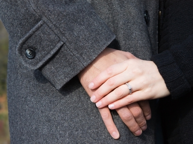 A couple holds hands.