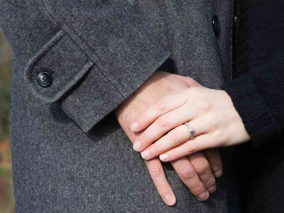A couple holds hands.