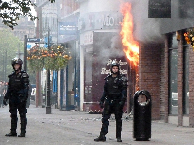Fire rips through a retail store in Manchester, in northwest England, Tuesday, marking a fourth night of violence in Britain. Looters have targeted electronics and clothing stores.
