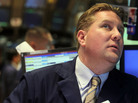 A trader at the New York Stock Exchange watches a monitor moments before the Federal Reserve announced it would keep interest rates low through at least 2013. The news reassured investors and helped sustain a rally. A trader at the New York Stock Exchange watches a monitor moments before the Federal Reserve announced it would keep interest rates low through at least 2013. The news reassured investors and helped sustain a rally.