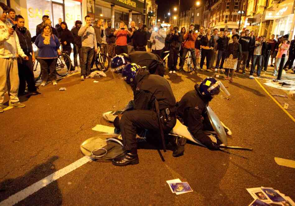 Violence and looting have spread across some of London's most impoverished neighborhoods. Here, police arrest another man in South London on Aug. 8. 