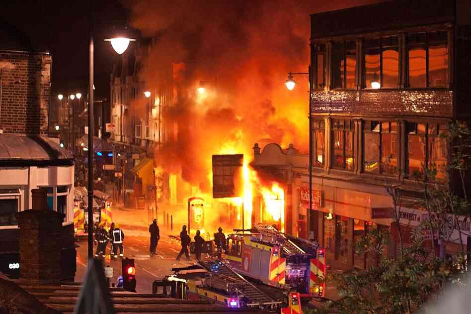 Buildings burn on Tottenham High Road in the North London suburb. A peaceful protest against Duggan's killing escalated into a riot on Aug.6.  