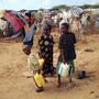 Children from southern Somalia fill jugs with water at a refugee camp in Mogadishu Tuesday. The number of people fleeing famine-hit areas of Somalia is likely to rise dramatically and could overwhelm international aid efforts in the Horn of Africa, a U.N. aid official said Tuesday. Children from southern Somalia fill jugs with water at a refugee camp in Mogadishu Tuesday. The number of people fleeing famine-hit areas of Somalia is likely to rise dramatically and could overwhelm international aid efforts in the Horn of Africa, a U.N. aid official said Tuesday.