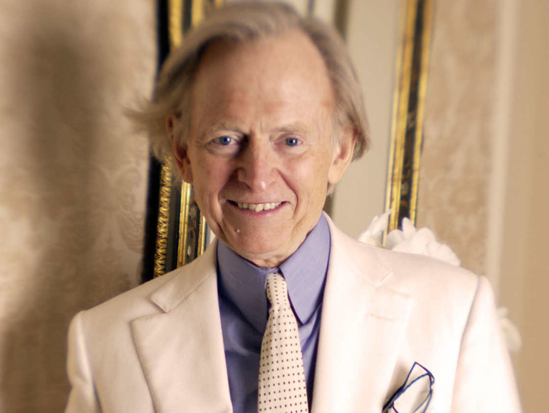 Author Tom Wolfe poses in one of his trademark three-piece suits.