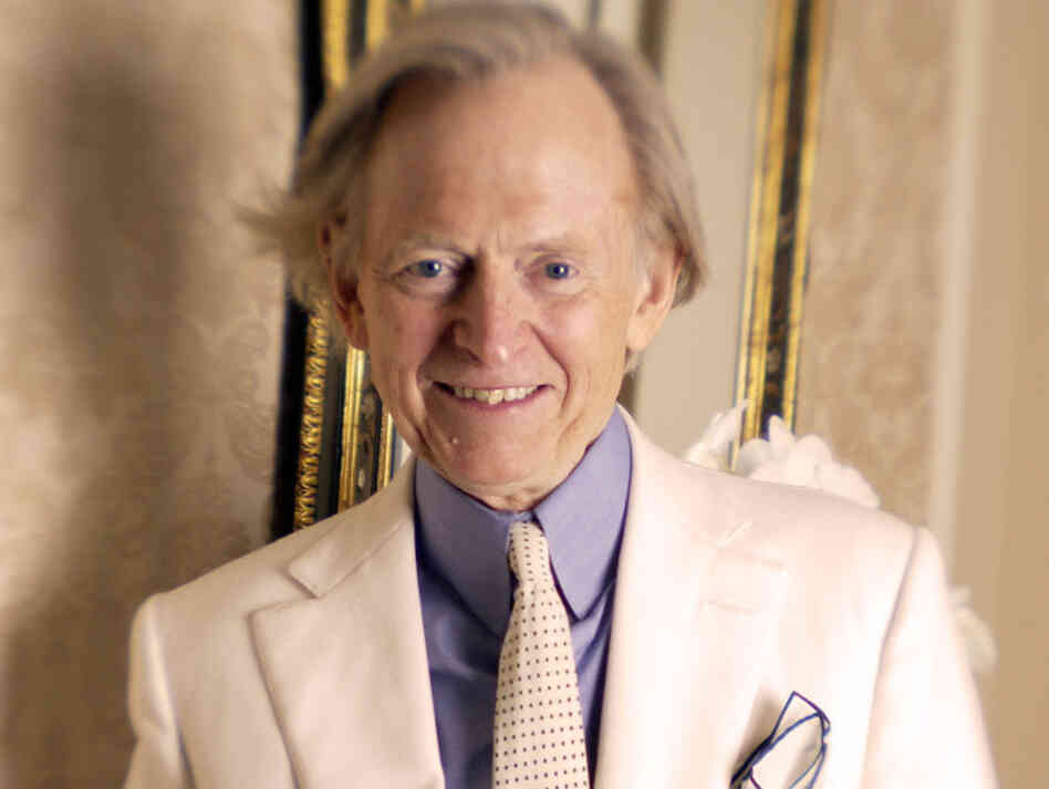Author Tom Wolfe poses in one of his trademark three-piece suits.