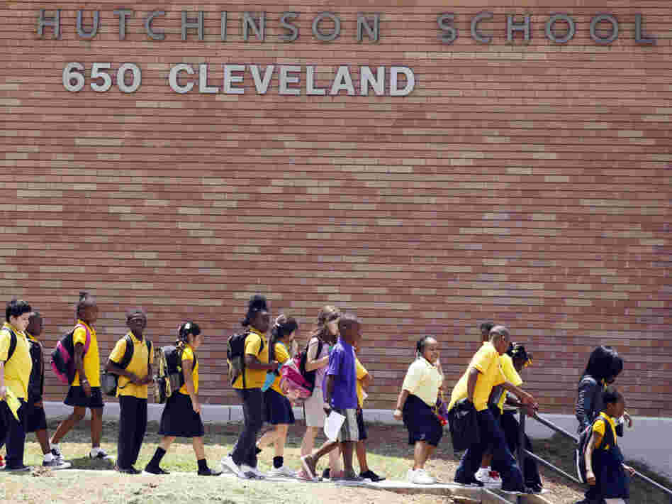 Students leave after the day's classes at Emma Hutchinson School, which has been identified as one of 44 schools involved in a test cheating scandal. Investigators have concluded that nearly half the city's schools allowed cheating to go unchecked for as long as a decade, beginning in 2001.