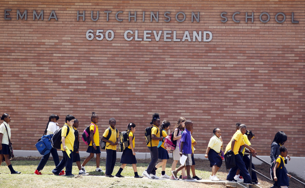 Students leave after the day's classes at Emma Hutchinson School, which has been identified as one of 44 schools involved in a test cheating scandal. Investigators have concluded that nearly half the city's schools allowed cheating to go unchecked for as long as a decade, beginning in 2001.