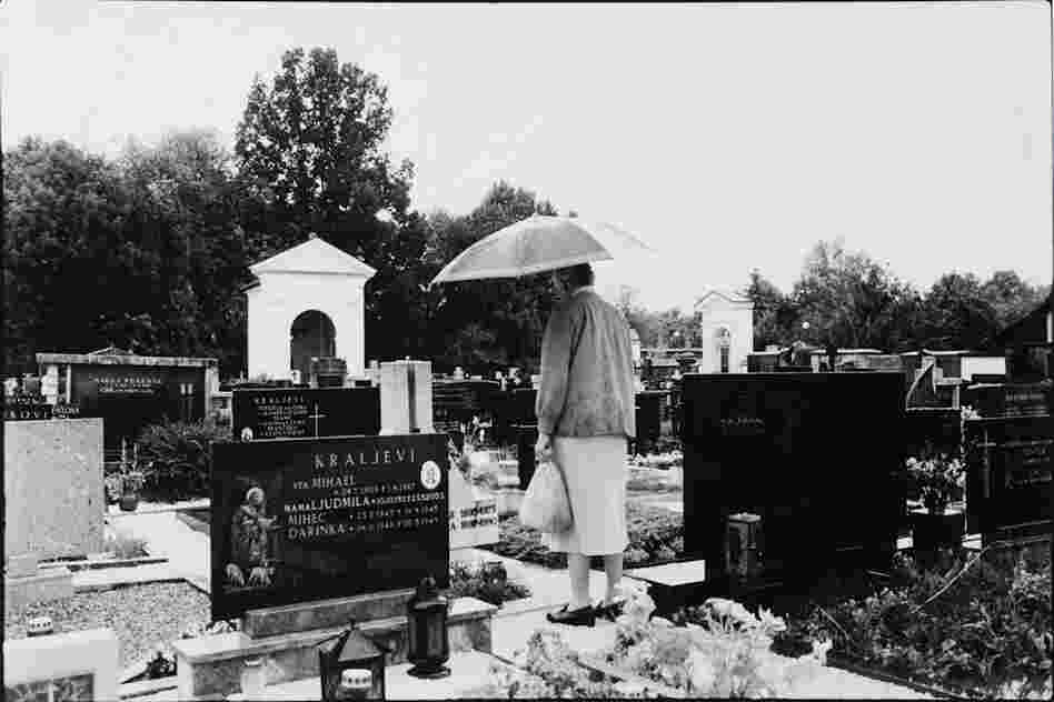 The Widow on her visit to her beloved husband's grave, bringing him flowers and a candle.