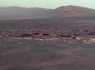 A portion of the west rim of Endeavour crater sweeps southward in this view from NASA's Mars Exploration Rover Opportunity. NASA adjusted the colors in this image. Fans of the film Capricorn One may want to see the original orange-tinted image. A portion of the west rim of Endeavour crater sweeps southward in this view from NASA's Mars Exploration Rover Opportunity. NASA adjusted the colors in this image. Fans of the film Capricorn One may want to see the original orange-tinted image.