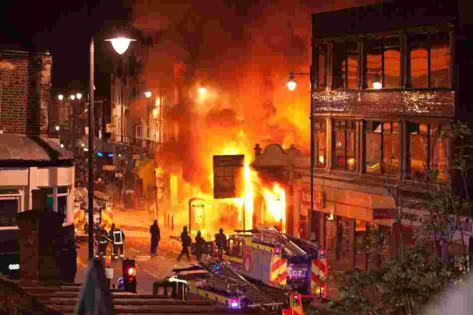 Buildings burn on Tottenham High Road in the North London suburb. A peaceful protest against Duggan's killing escalated into a riot on Aug.6.  