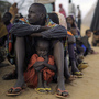 A Somali father sits with his daughter at the head of the line at a refugee camp registration center in Dabaab in northeastern Kenya, Aug. 2, 2011. International aid agencies are struggling to bring in more supplies to drought-stricken Somalia and neighboring Kenya. A Somali father sits with his daughter at the head of the line at a refugee camp registration center in Dabaab in northeastern Kenya, Aug. 2, 2011. International aid agencies are struggling to bring in more supplies to drought-stricken Somalia and neighboring Kenya.