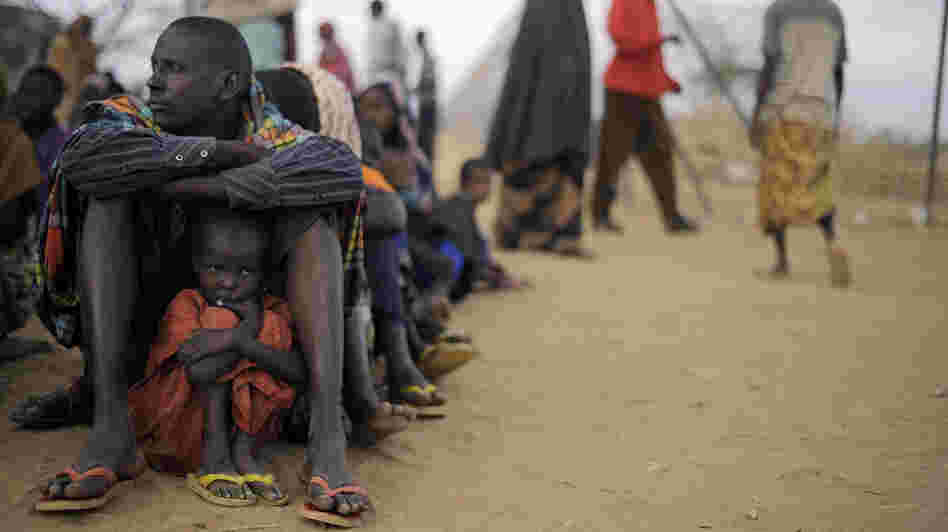 A Somali father sits with his daughter at the head of the line at a refugee camp registration center in Dabaab in northeastern Kenya, Aug. 2, 2011. International aid agencies are struggling to bring in more supplies to drought-stricken Somalia and neighboring Kenya. A Somali father sits with his daughter at the head of the line at a refugee camp registration center in Dabaab in northeastern Kenya, Aug. 2, 2011. International aid agencies are struggling to bring in more supplies to drought-stricken Somalia and neighboring Kenya.