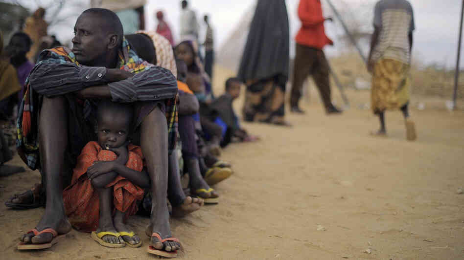 A Somali father sits with his daughter at the head of the line at a refugee camp registration center in Dabaab in northeastern Kenya, Aug. 2, 2011. International aid agencies are struggling to bring in more supplies to drought-stricken Somalia and neighboring Kenya. A Somali father sits with his daughter at the head of the line at a refugee camp registration center in Dabaab in northeastern Kenya, Aug. 2, 2011. International aid agencies are struggling to bring in more supplies to drought-stricken Somalia and neighboring Kenya.