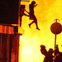 After hearing people shout that a woman was about to jump from a burning building, photographer Amy Weston snapped this image of the woman's leap to safety.