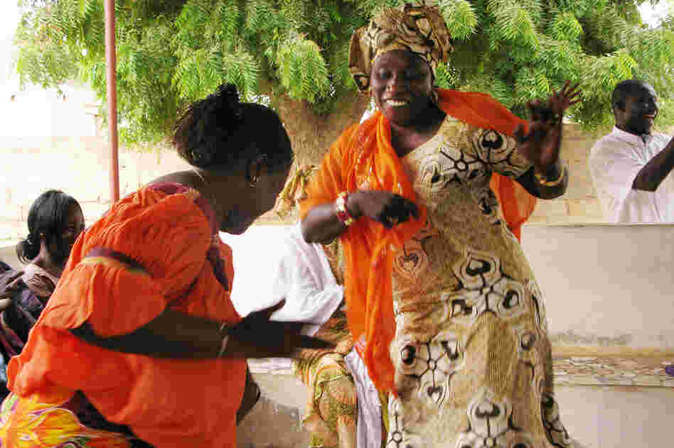 Grandmothers or senior women, called  les grandes-meres, dance during a gathering for women in Guereo, Senegal. In a tradition of solidarity called  bajenu gox, the older women assist younger women in the community.