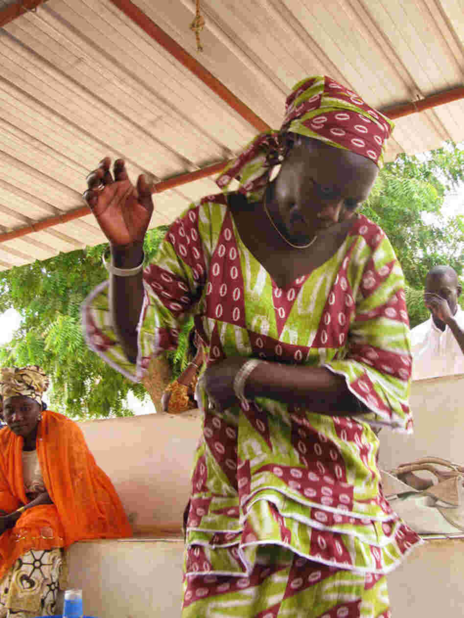 The women spontaneously break into song and dance during the discussion.