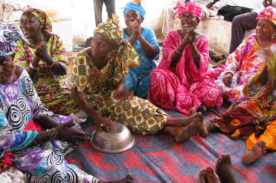The women sing during a health care and advice session.