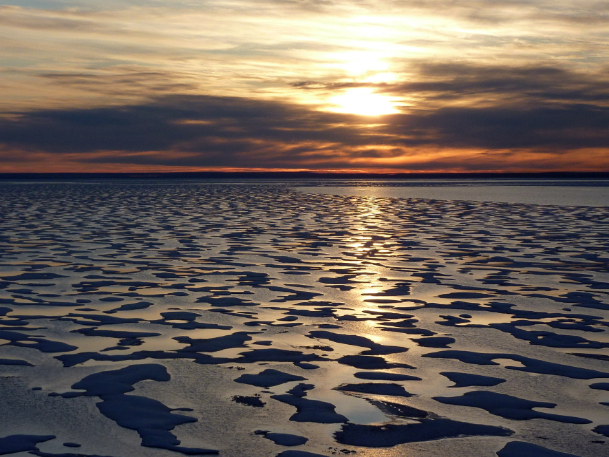 Much  of the Northwest Passage experiences 24 hours  of light during the summer months. But as the Louis heads further  south toward Cambridge Bay, a sunset appears on the  horizon.