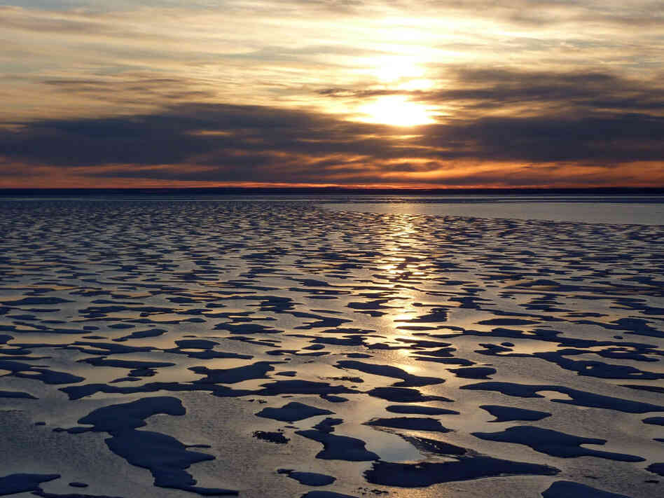 Much  of the Northwest Passage experiences 24 hours  of light during the summer months. But as the Louis heads further  south toward Cambridge Bay, a sunset appears on the  horizon.