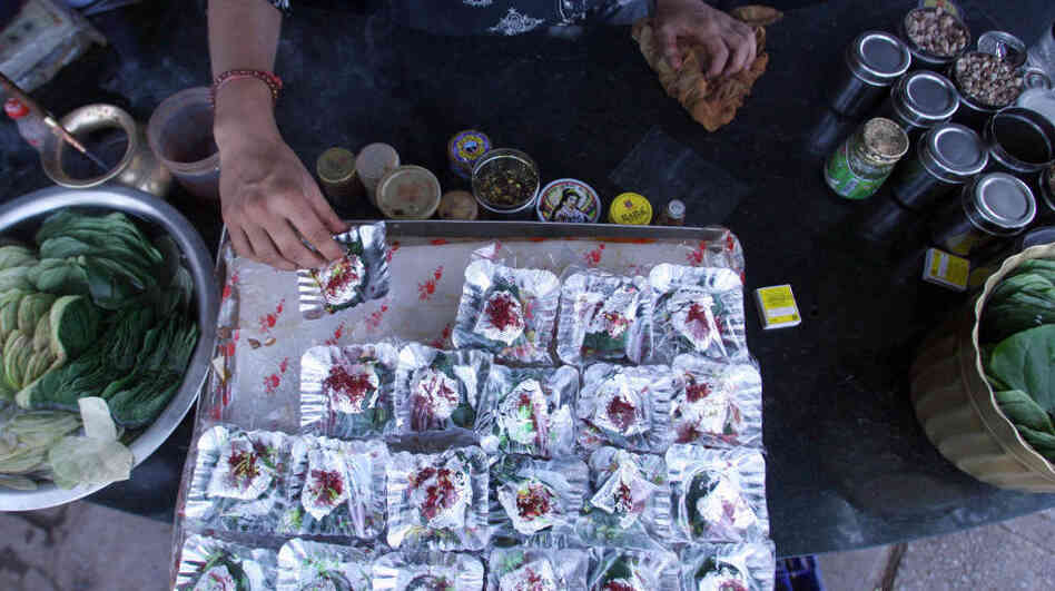 In India, the centuries-old tradition of chewing betel leaves, or paan, spread with spices and sweeteners is losing popularity. In this file photo from 2006, an Indian shopkeeper arranges silver foils of paan at his roadside shop in New Delhi. In India, the centuries-old tradition of chewing betel leaves, or paan, spread with spices and sweeteners is losing popularity. In this file photo from 2006, an Indian shopkeeper arranges silver foils of paan at his roadside shop in New Delhi.