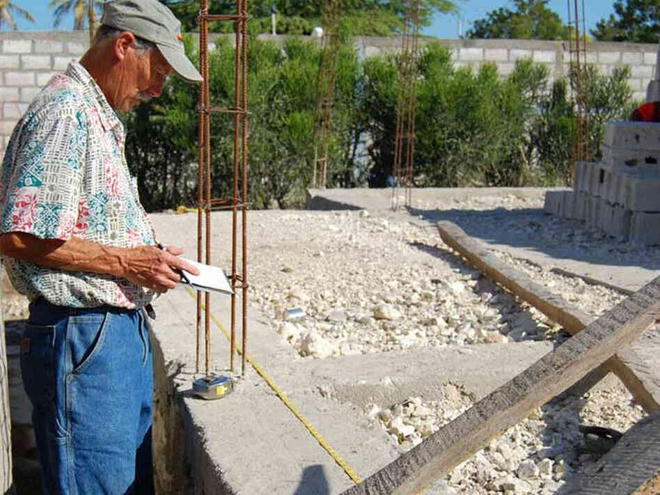 Tim Myers measuring the subpar foundation at the school site.