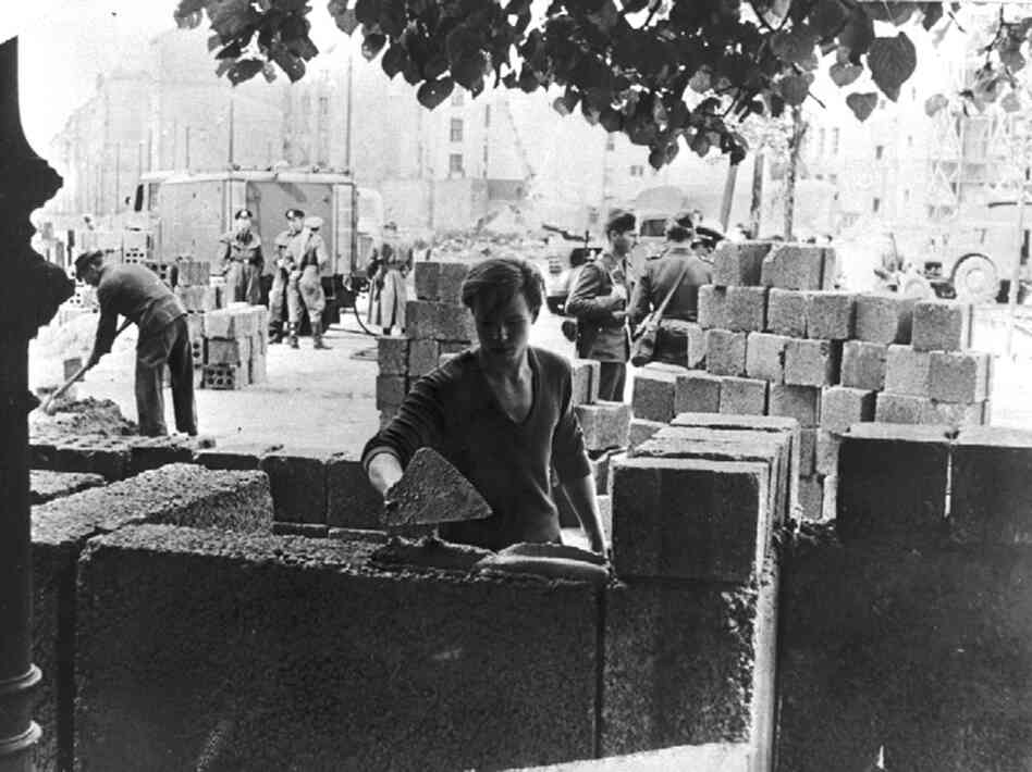 An East German worker lays some of the first stone blocks of the wall shortly after the border between East and West Berlin was sealed in August 1961. 