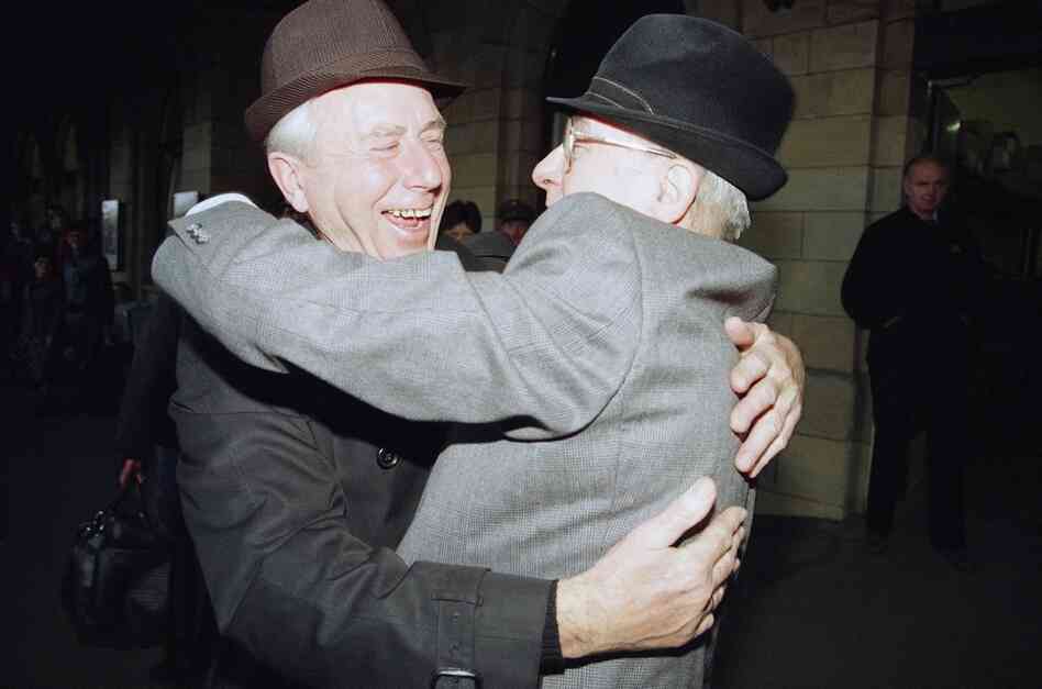 Two men from West (left) and East Germany embrace each other after the arrival of a special train at the Helmstedt railway station on Nov. 10, 1989. 
