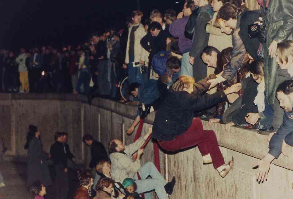 West Berliners help East Berliners over the wall on Nov. 10, 1989. 