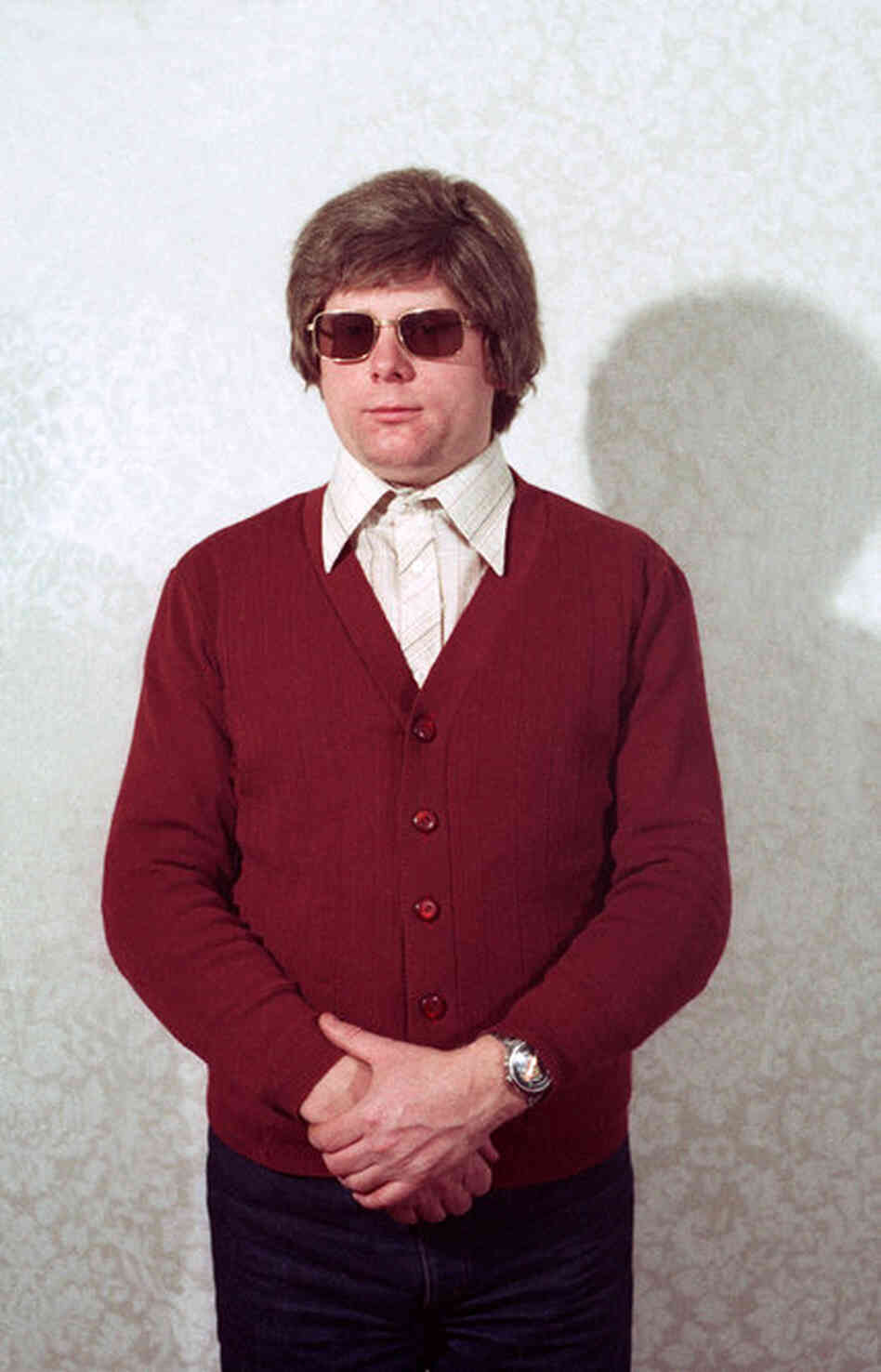 The photos show Stasi agents dressed in various disguises, ranging from a Russian mafioso to the casual middle-aged man to a tourist with cameras.