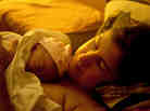 Shannon Earle holds her new baby Kiera Breen Earle, moments after being born at their home. This is Earle's third child.