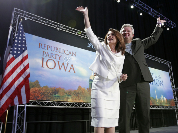 Republican presidential candidate Rep. Michele Bachmann (R-MN) and her husband, Marcus, wave to the crowd after she speaks at the Iowa Republican Party's straw poll in Ames, Iowa, on Saturday. Bachmann won the poll with 4,823 votes.