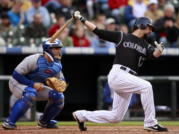 Catcher Brad Ausmus (left), with the L.A. Dodgers in May 2009, is at the ready as the Colorado Rockies' Todd Helton bats during a game in Denver.