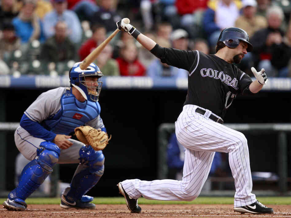 Catcher Brad Ausmus (left), with the L.A. Dodgers in May 2009, is at the ready as the Colorado Rockies' Todd Helton bats during a game in Denver.
