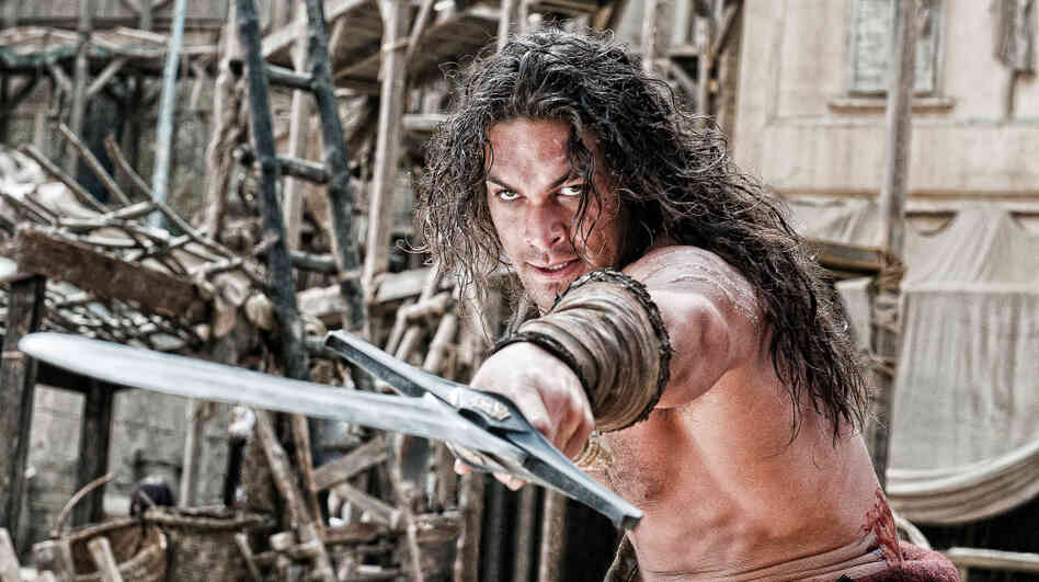 Conan O'Barbarian: Conan (Jason Momoa) is charged with using his wooden stoicism to prevent ancient warmongers from unleashing their supernatural hammy acting on an unsuspecting public. Though the film's lore tells us he was born on a battlefield, in truth this Conan was born out of Hollywood's current joint lust for remakes and sword-and-sandals mythos. Conan O'Barbarian: Conan (Jason Momoa) is charged with using his wooden stoicism to prevent ancient warmongers from unleashing their supernatural hammy acting on an unsuspecting public. Though the film's lore tells us he was born on a battlefield, in truth this Conan was born out of Hollywood's current joint lust for remakes and sword-and-sandals mythos.