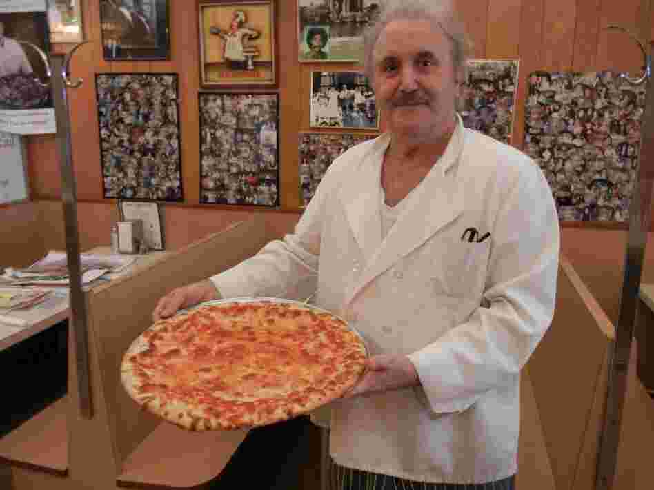 Nick Azzaro, owner of Papa's Tomato Pies, poses with one of his creations. Azzaro, who is now 64, says he's been making pizzas since he was 14 years old.